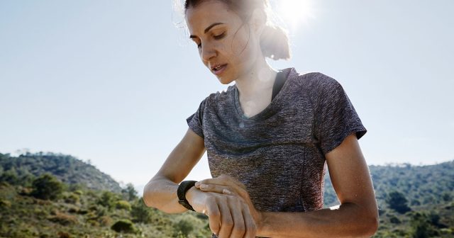 A runner checking running data on running watch 